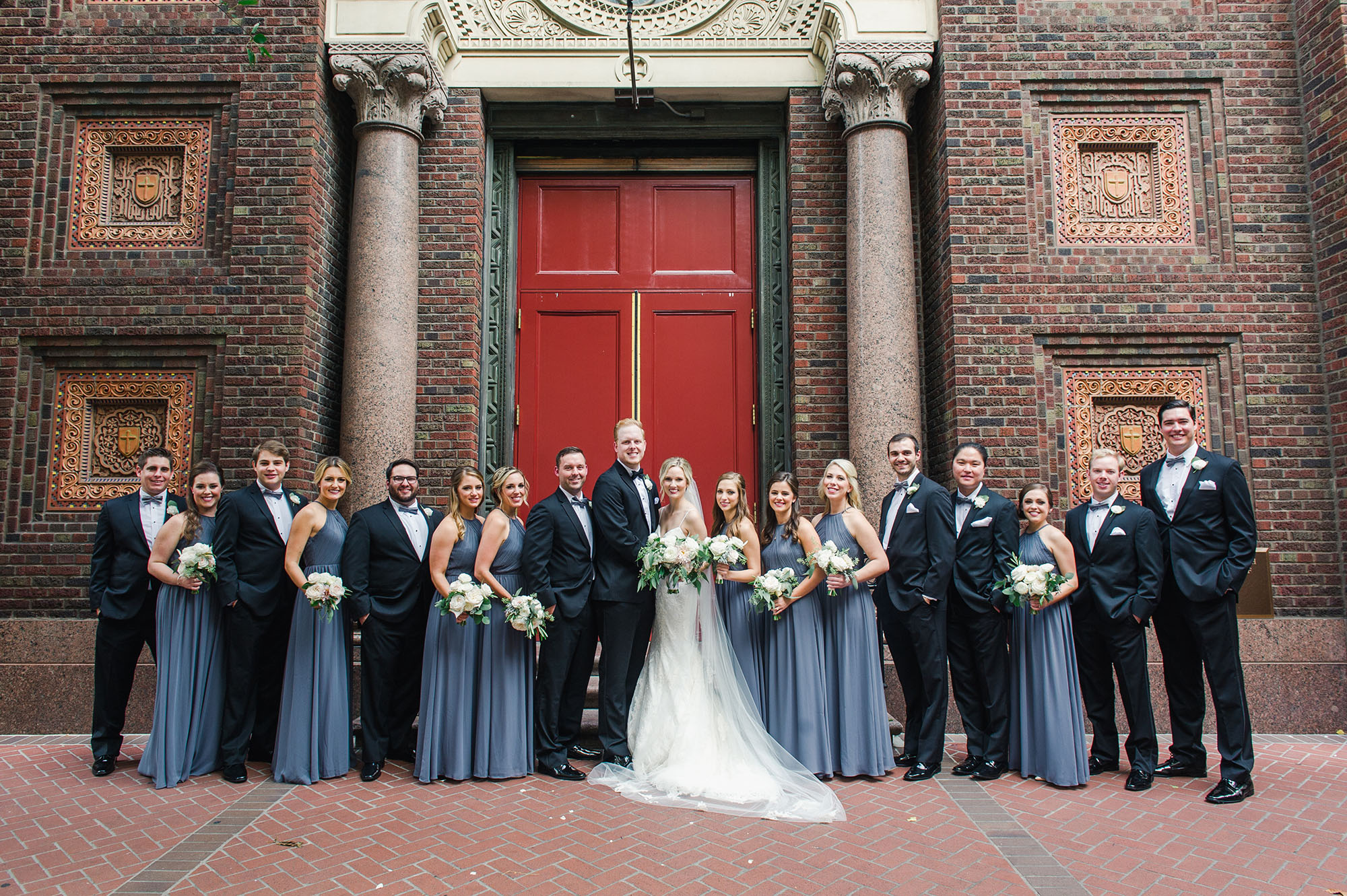 Bride, groom, and wedding party outside the church