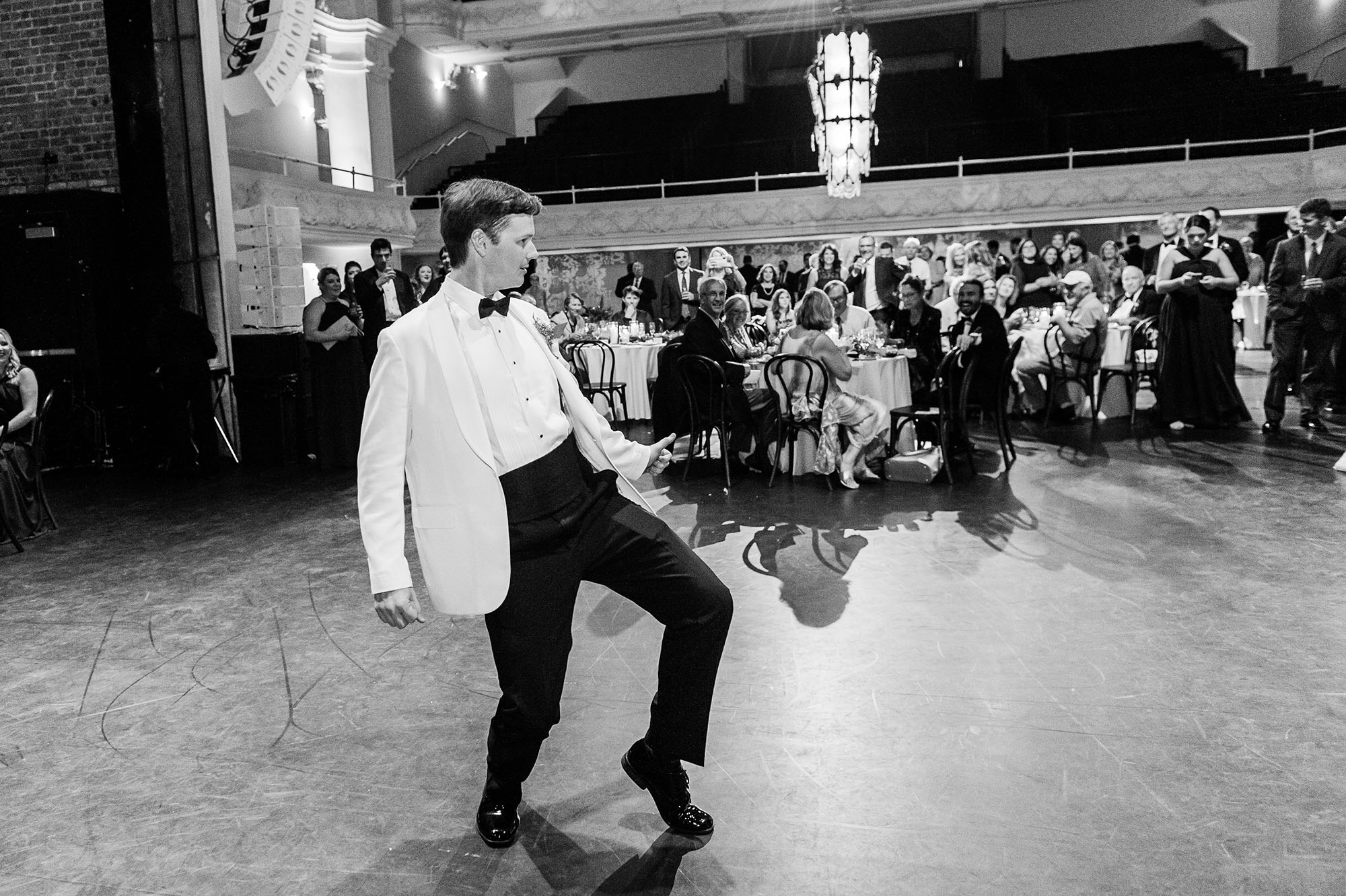 Groom dancing at reception