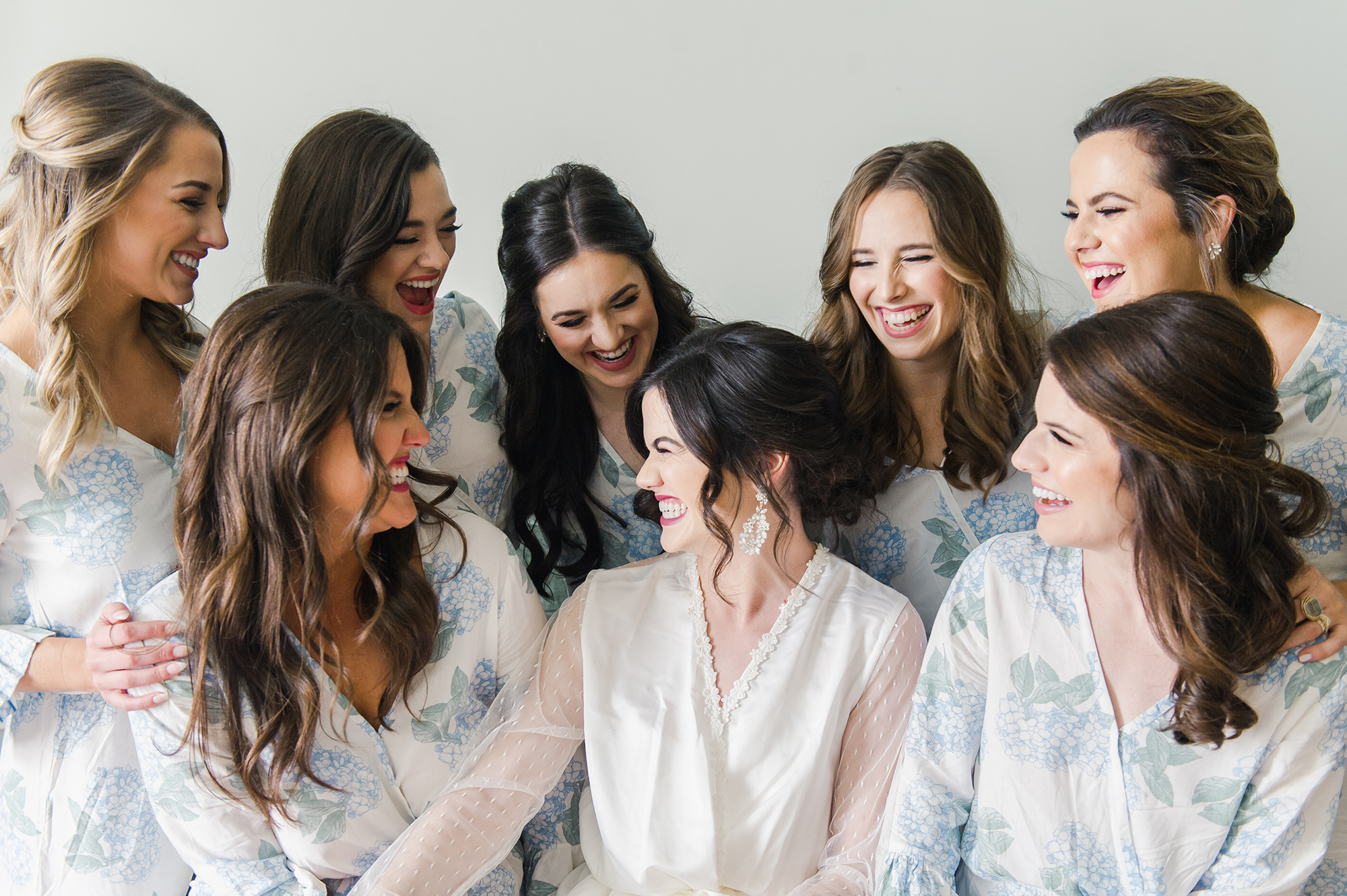 Bride laughing with bridesmaids