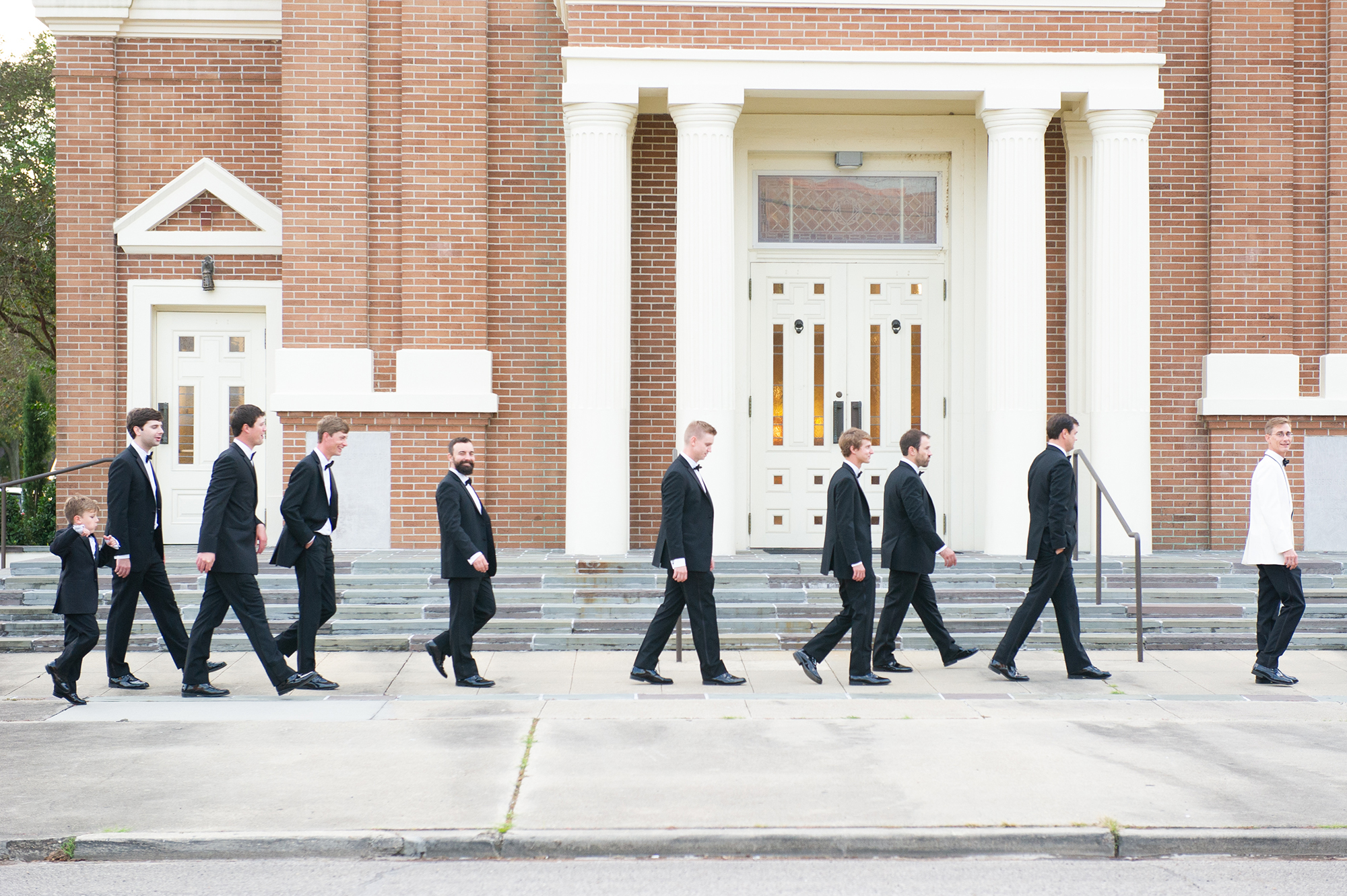 Groom and groomsmen walking to church