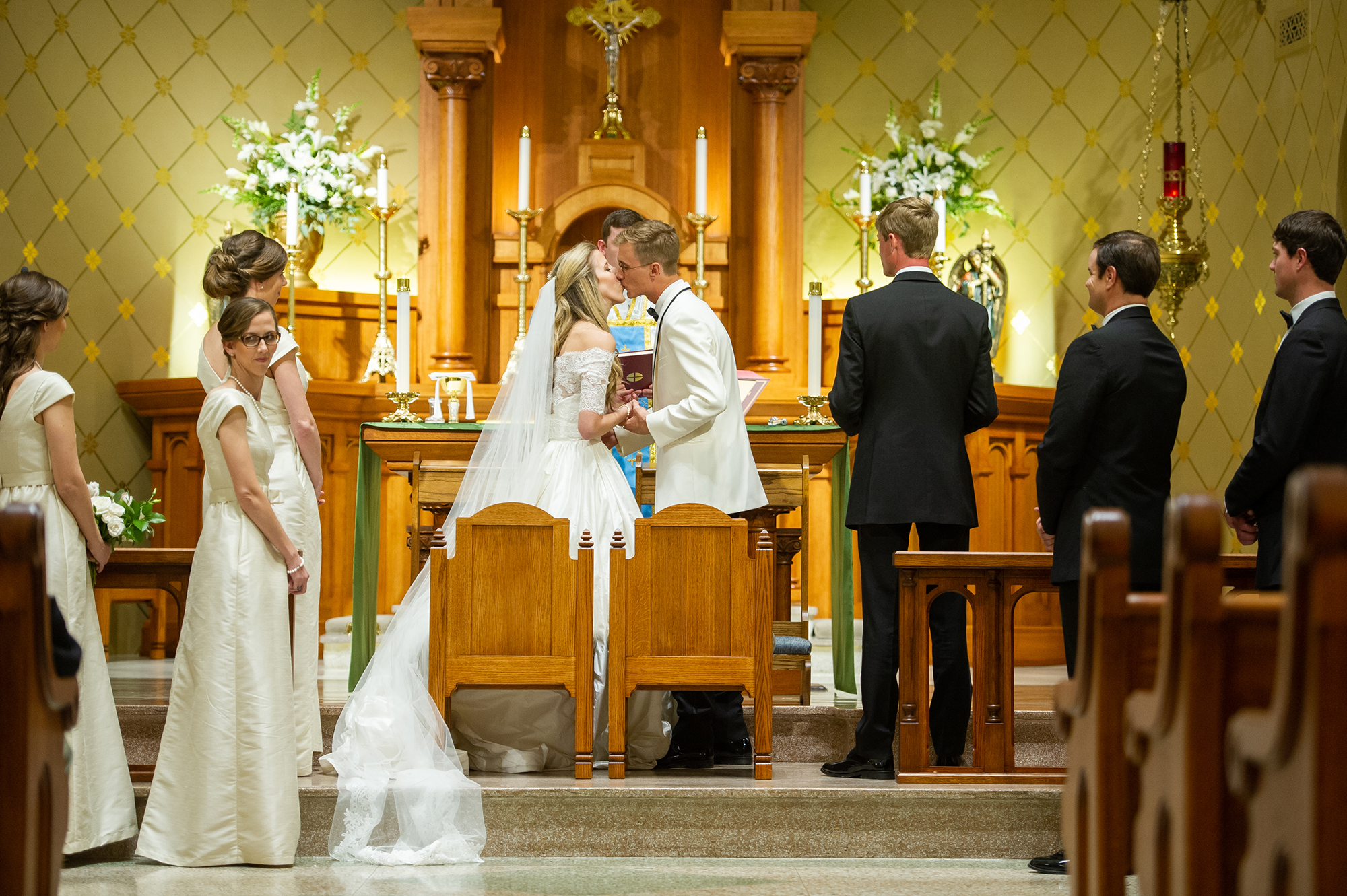 Bride and groom kissing at church wedding ceremony