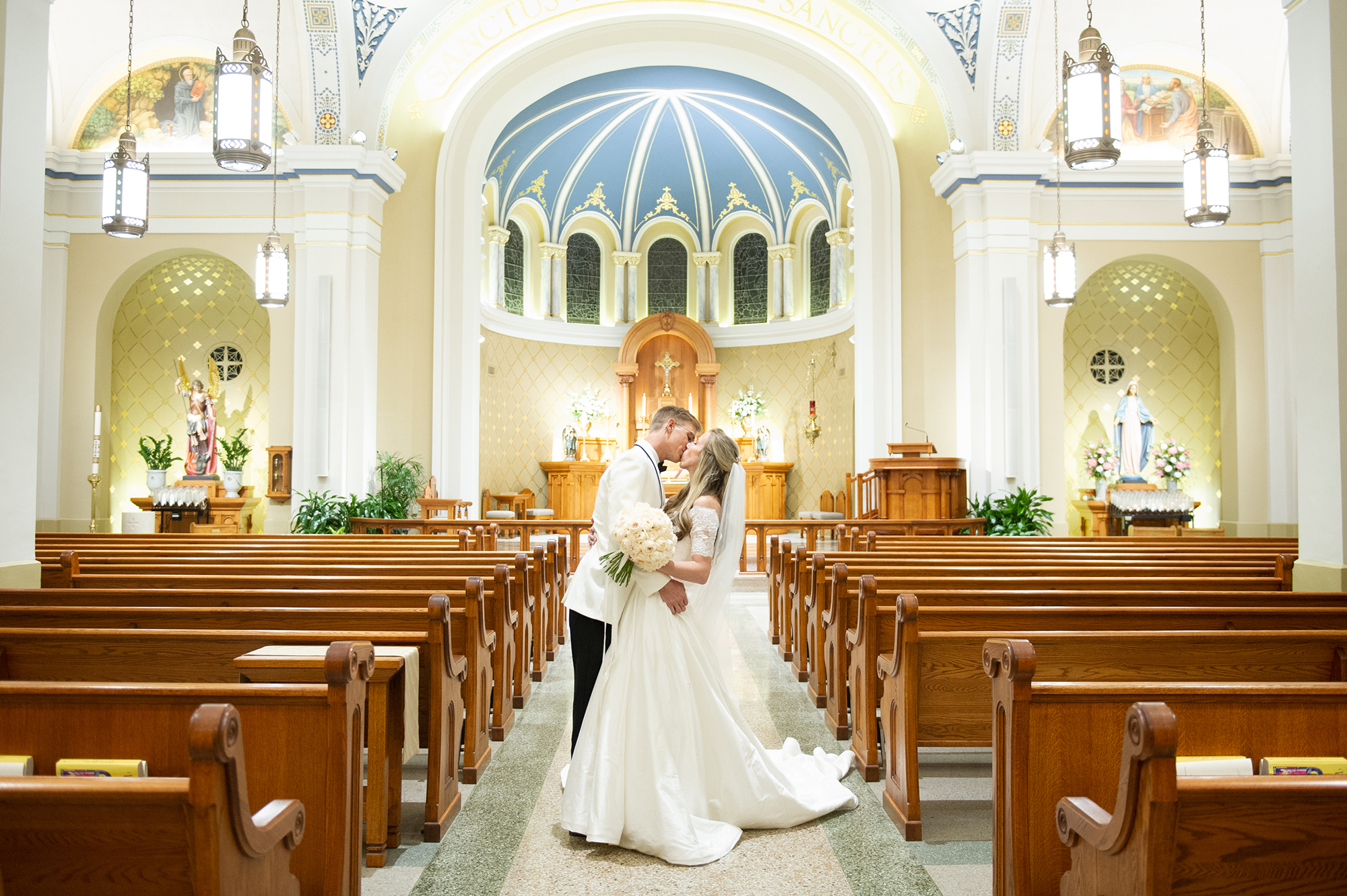 Bride and groom kissing in church