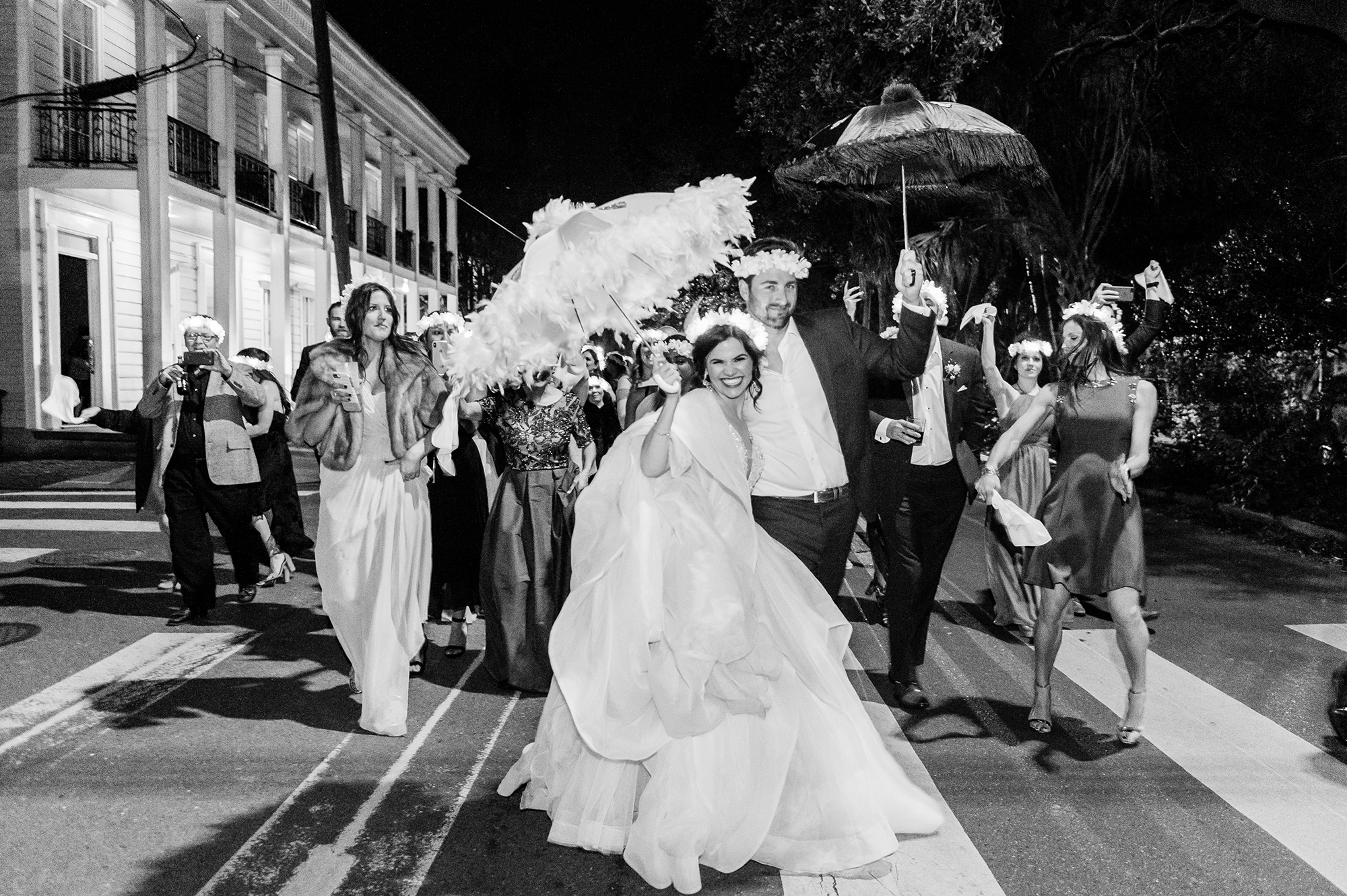 Bride and groom with parasols during second line