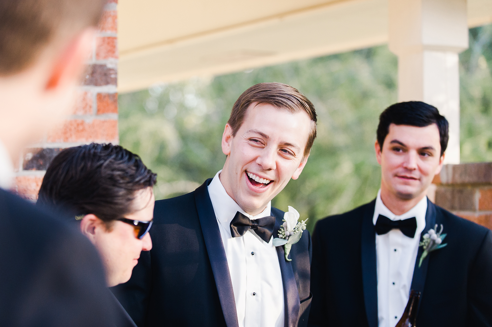 Groom laughing with groomsmen