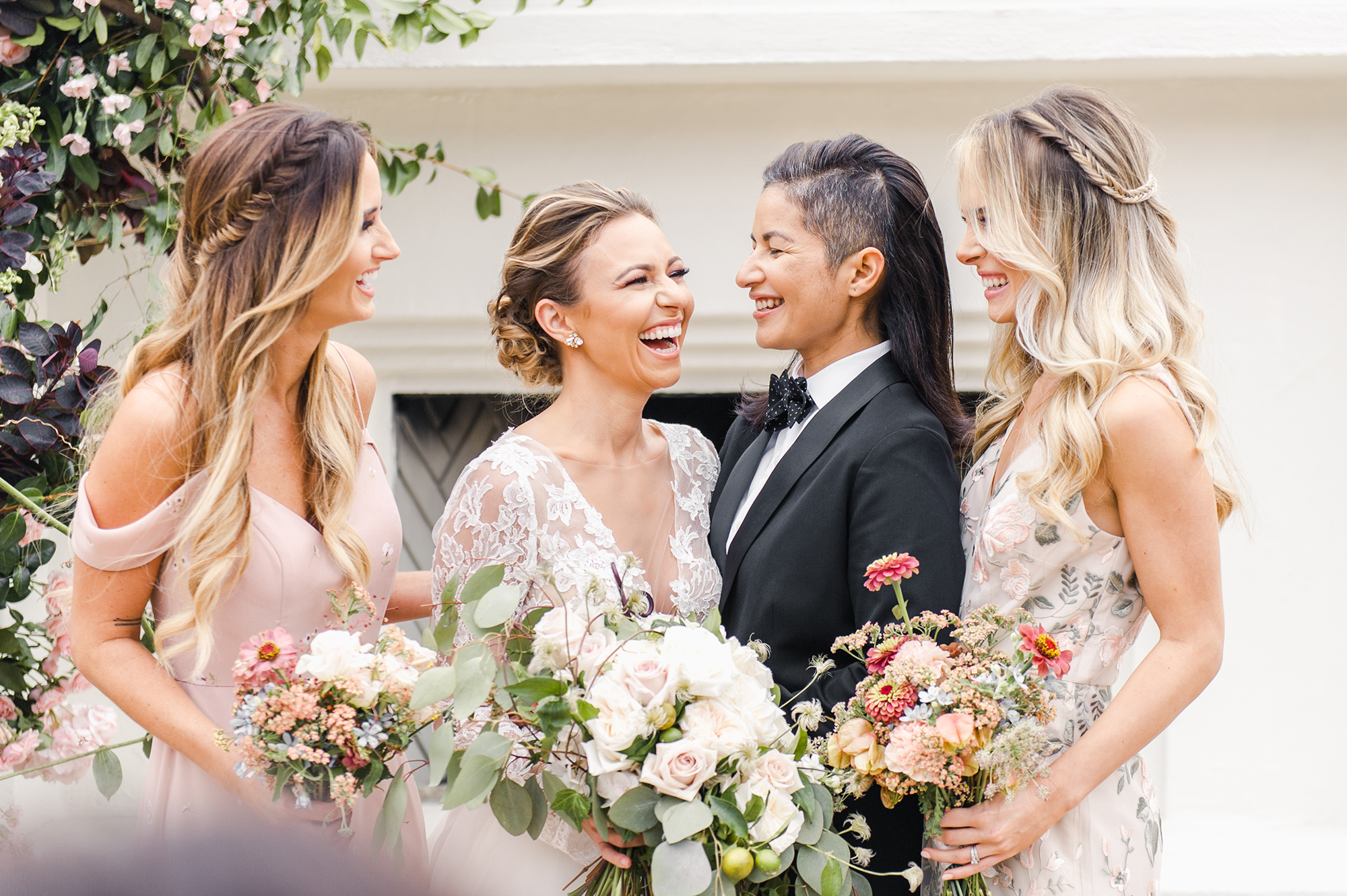 Brides laughing with bridesmaids