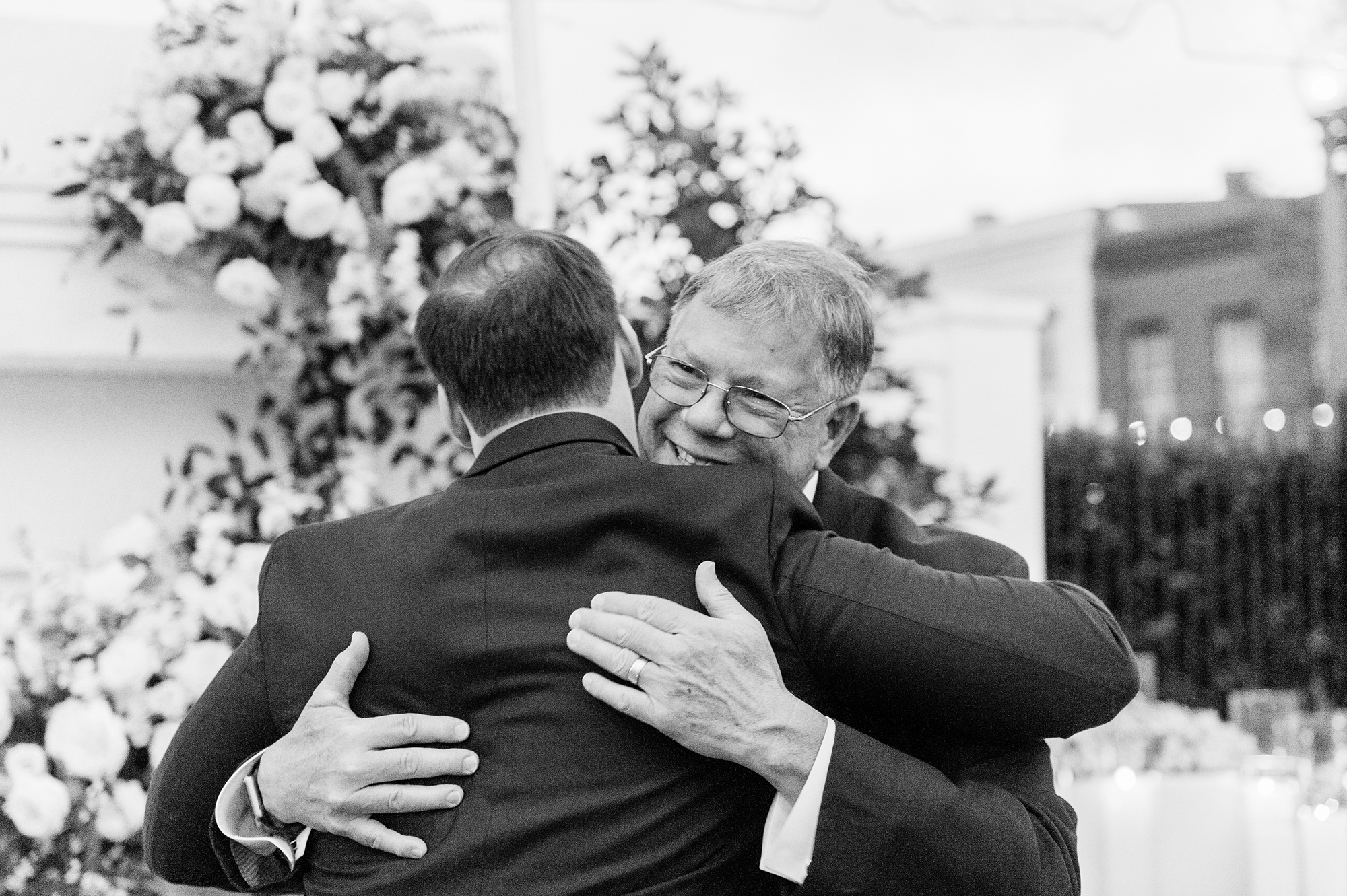 groom hugging bride's father