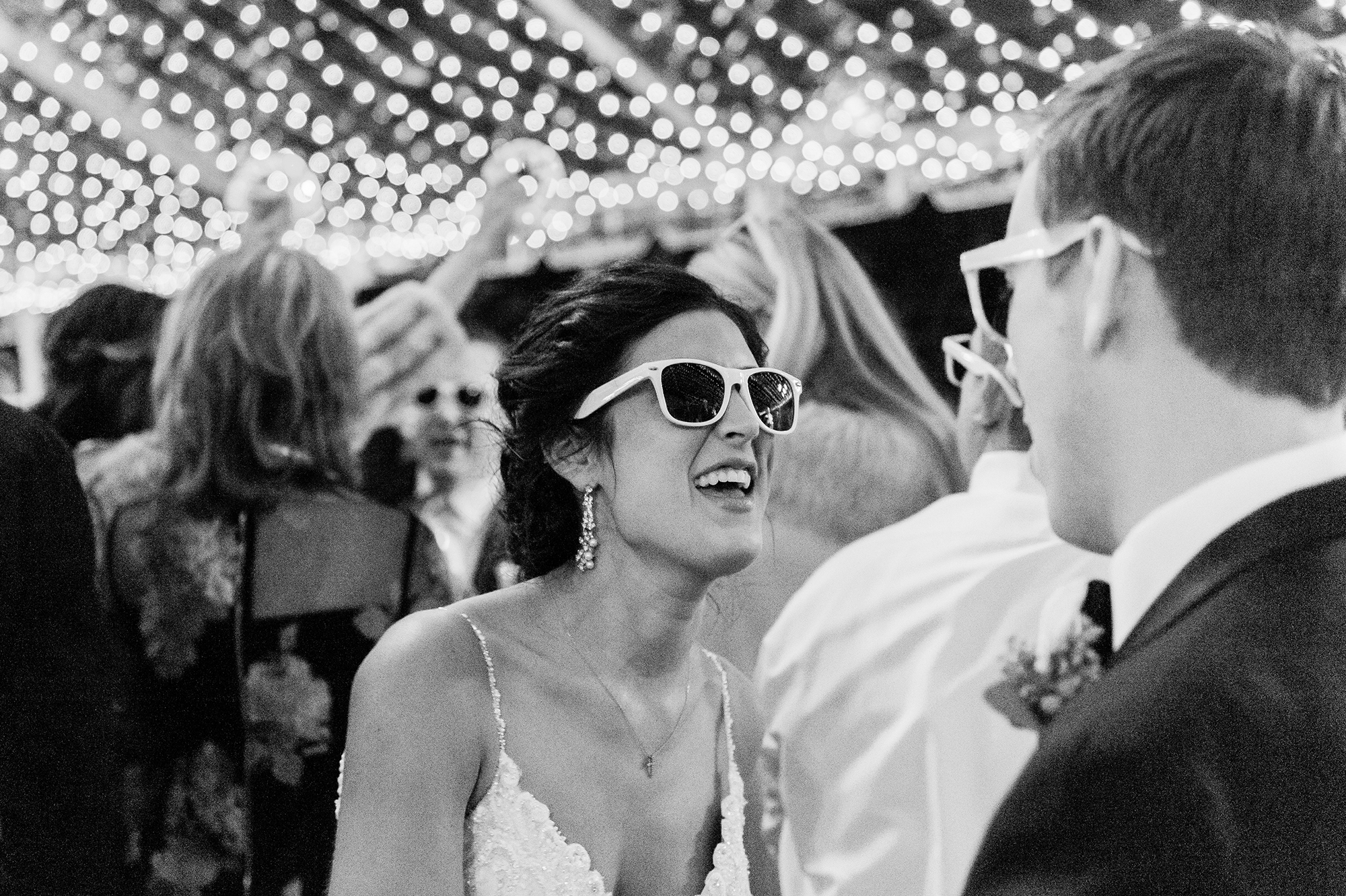 Bride and groom dancing in sunglasses