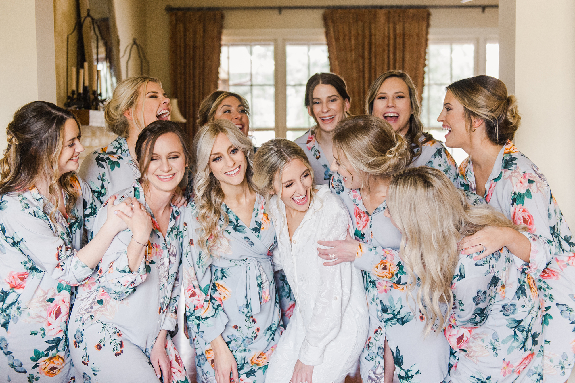 bride laughing bridesmaids in robes