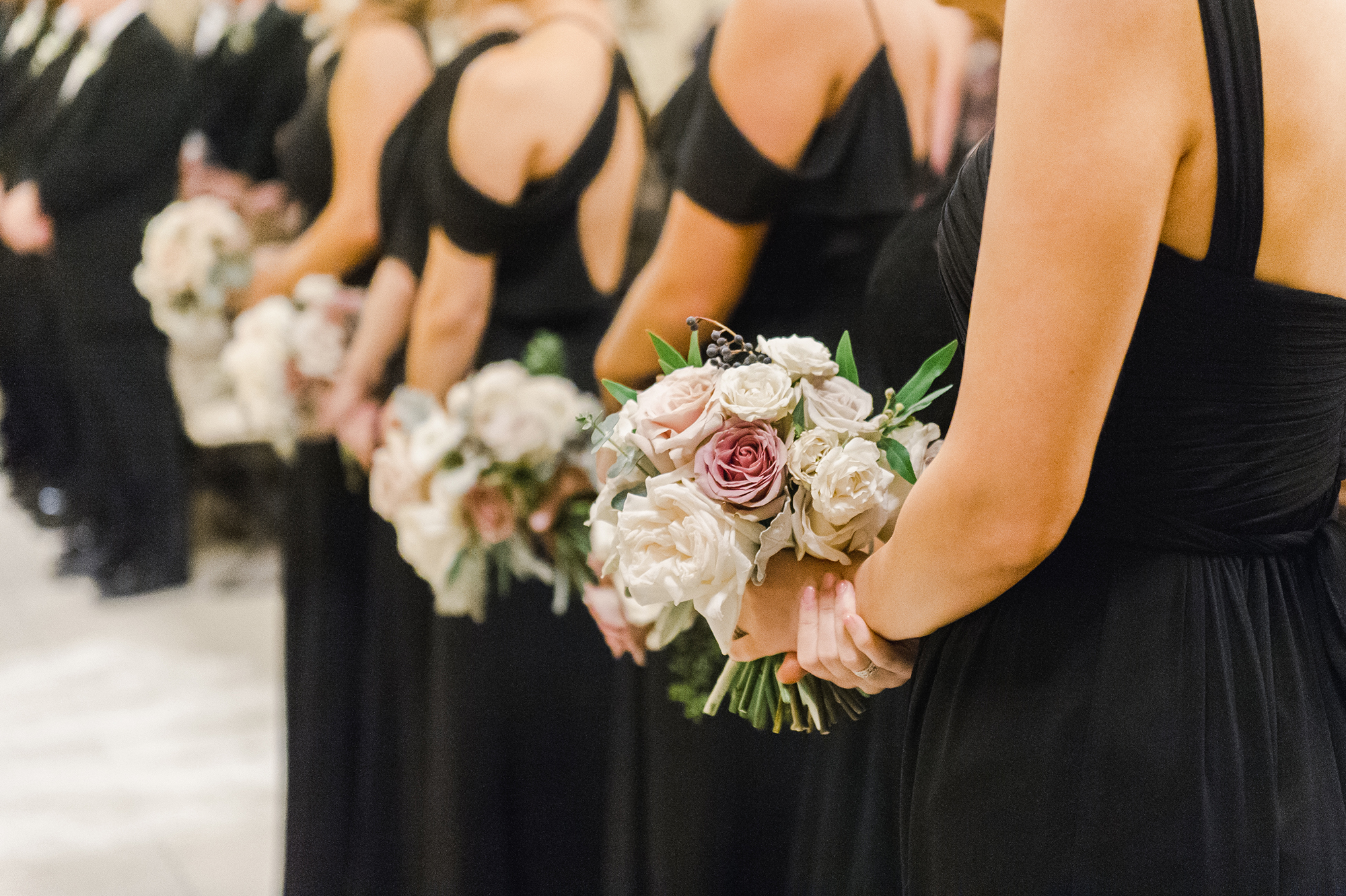 bridesmaids and bouquets in church during ceremony