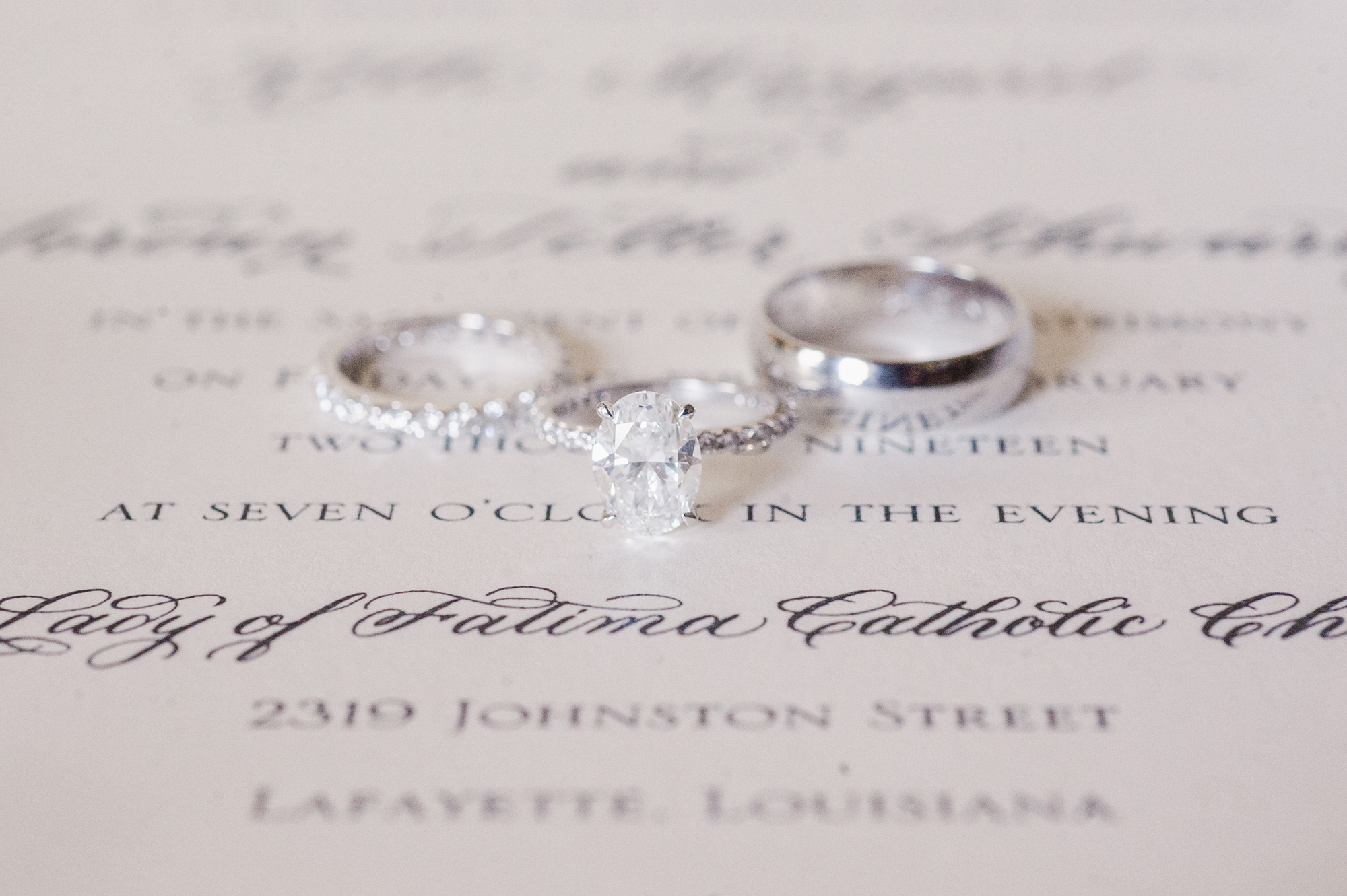 wedding and engagement rings on invitation